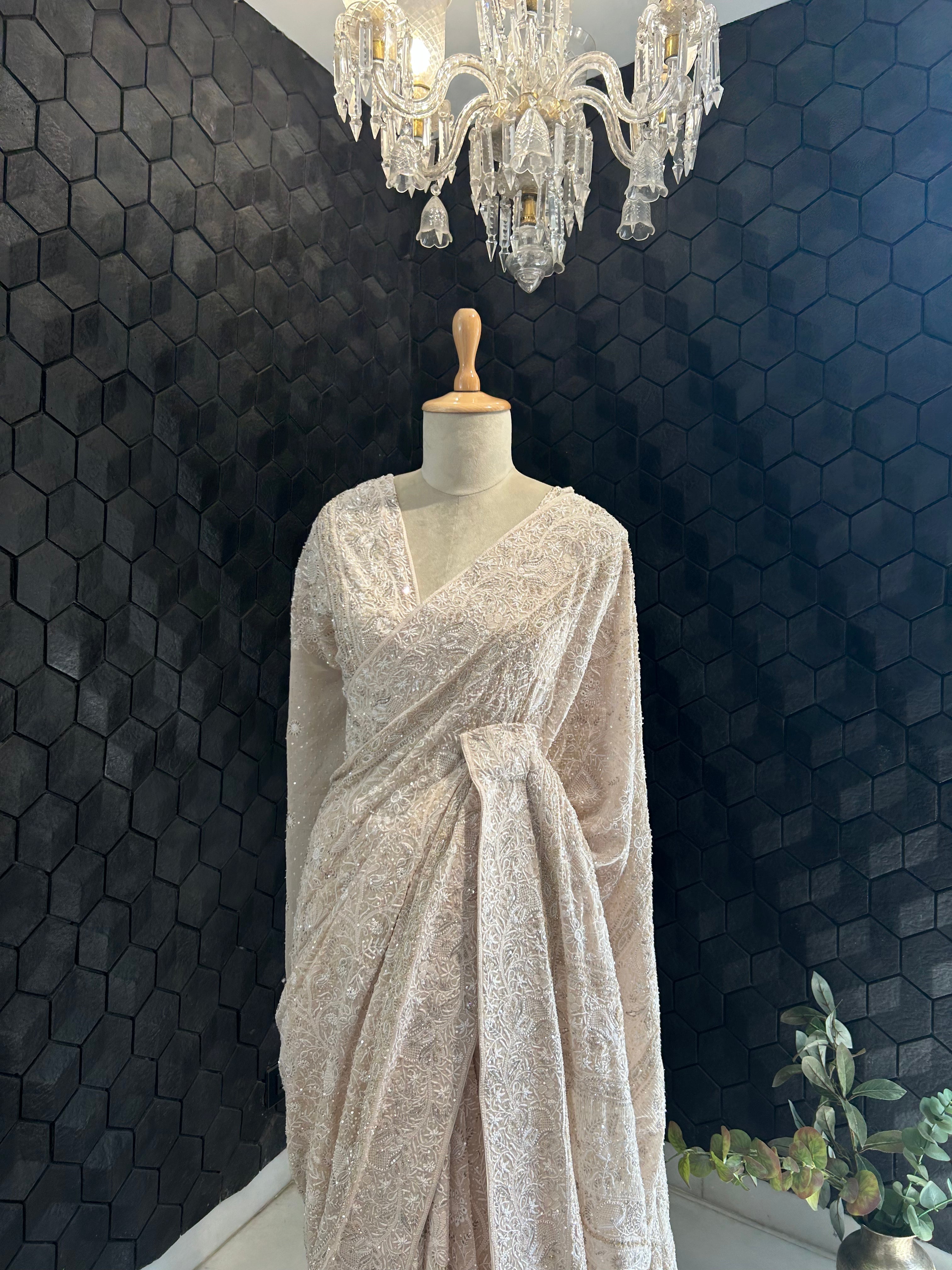PREMIUM DULL PEACH GEORGETTE CHIKANKARI SAREE WITH STATEMENT FLOWER MOTIFS