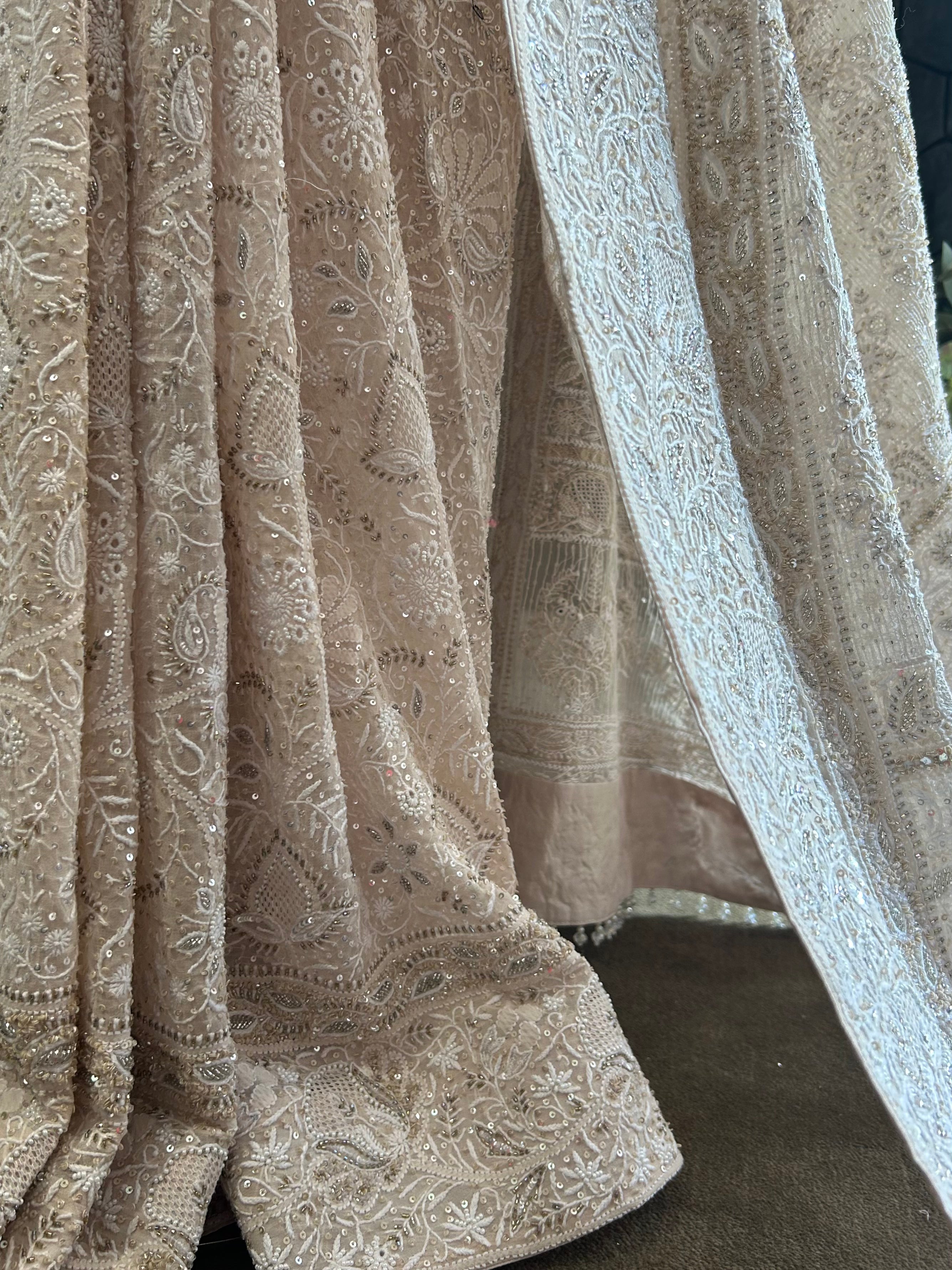 PREMIUM DULL PEACH GEORGETTE CHIKANKARI SAREE WITH STATEMENT FLOWER MOTIFS