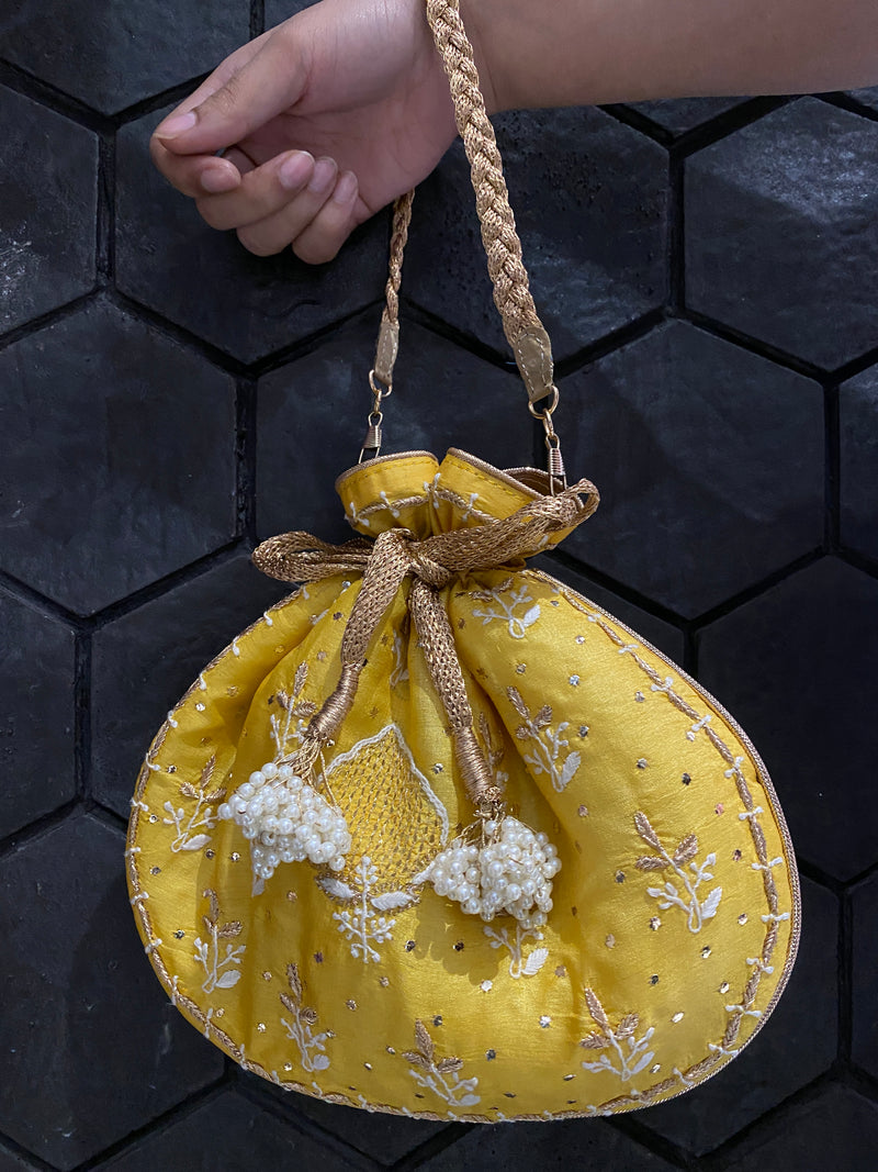 Yellow silk potli bag with chikankari and zari embroidery