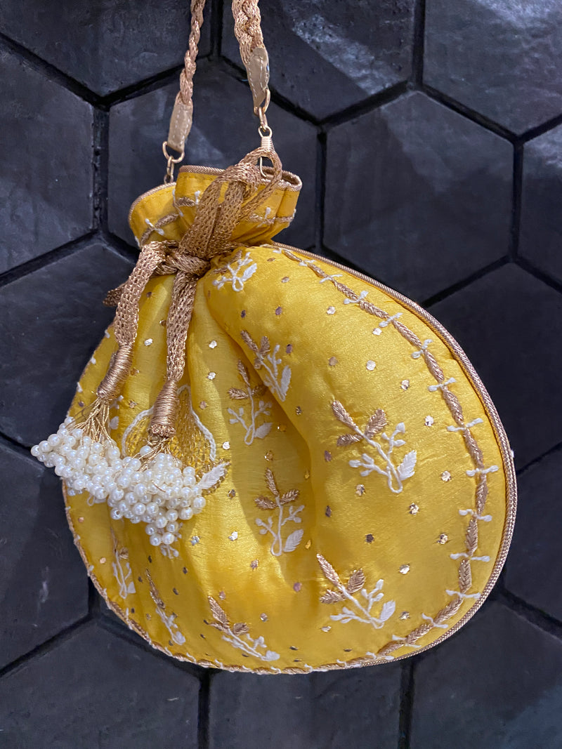 Yellow silk potli bag with chikankari and zari embroidery